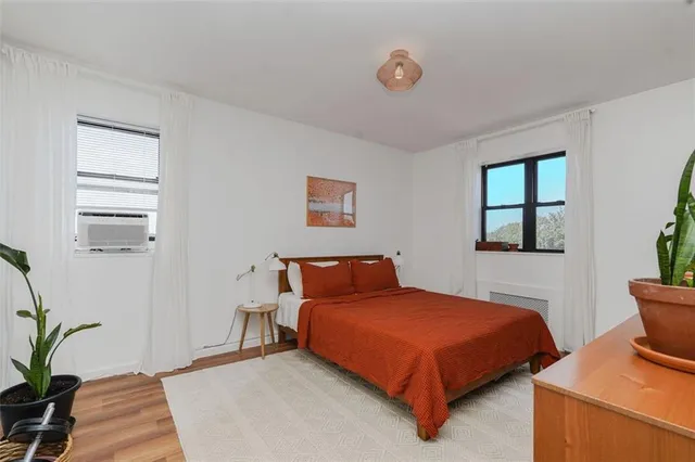 a bedroom with two beds and potted plant