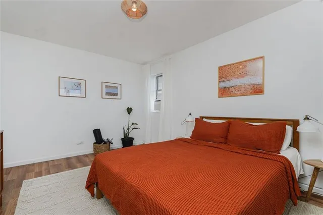 a bedroom with bed and painting on the wall