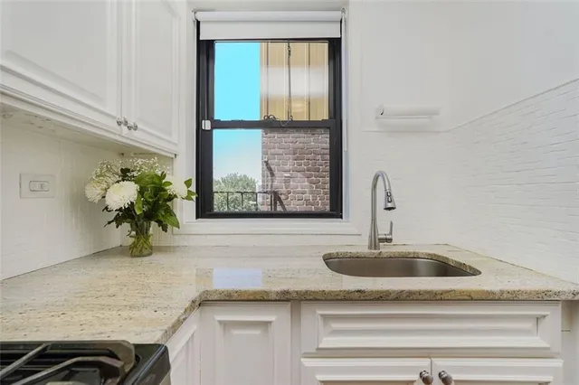 a sink with a granite top and a faucet