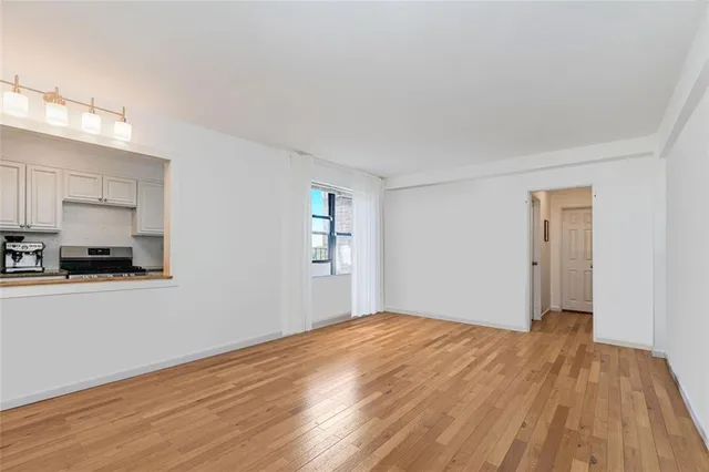 a view of a kitchen with wooden floor and a sink