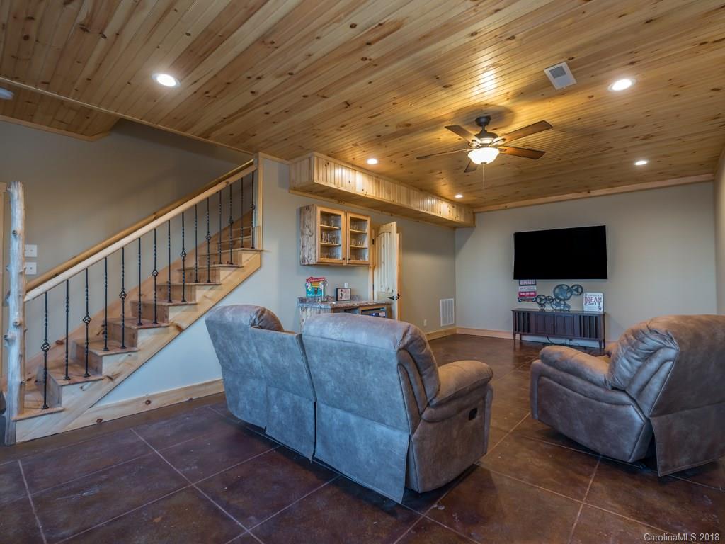 2189 Judes Gap Road Mill Spring, NC 28756 - Photo 14 of 22 a living room with furniture and a flat screen tv