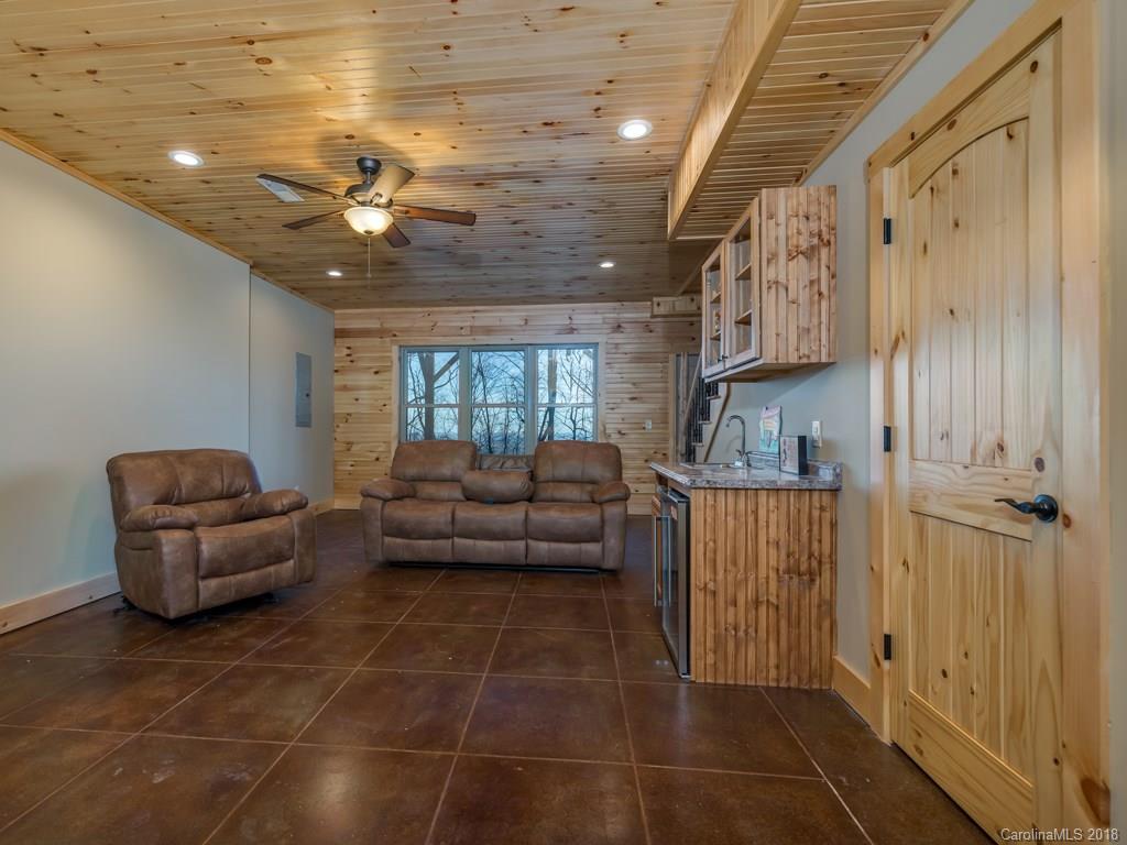 2189 Judes Gap Road Mill Spring, NC 28756 - Photo 15 of 22 a living room with furniture and a chandelier