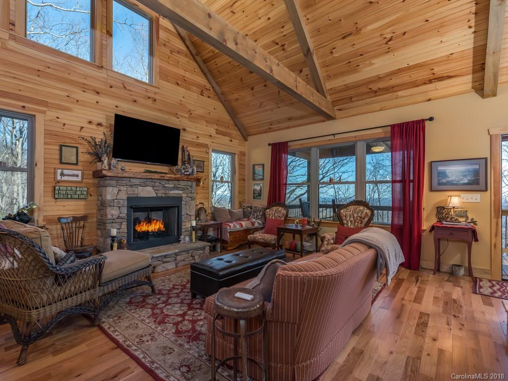 2189 Judes Gap Road Mill Spring, NC 28756 - Photo 5 of 22 a living room with furniture a flat screen tv and a fireplace
