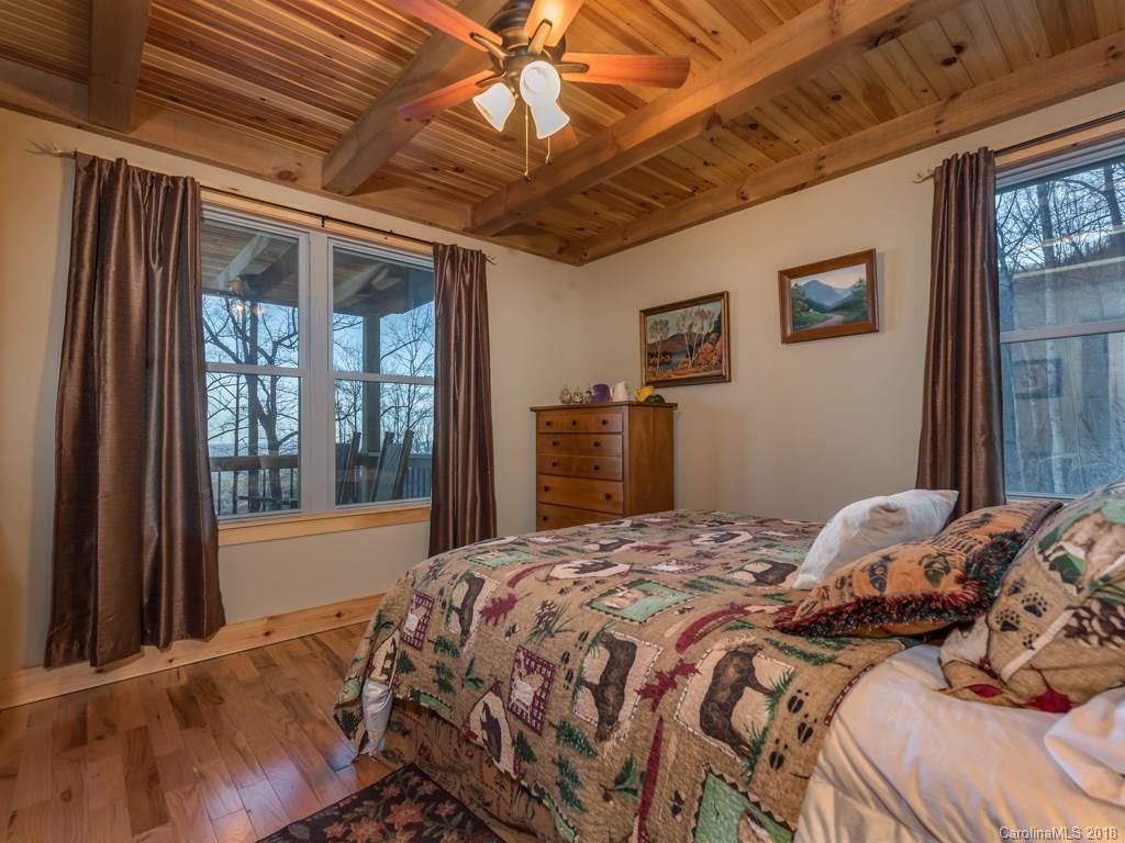 2189 Judes Gap Road Mill Spring, NC 28756 - Photo 10 of 22 a bedroom with a large bed and a window