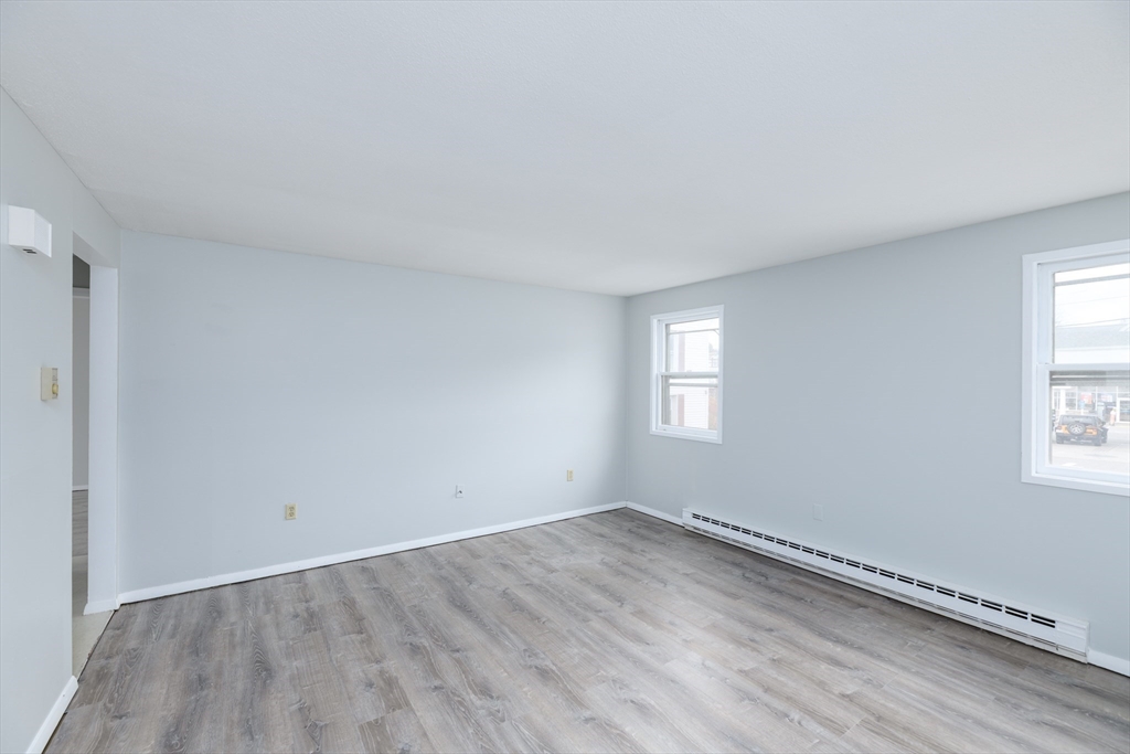504 Main Street Sturbridge, MA 01518 - Photo 14 of 25 an empty room with wooden floor and window