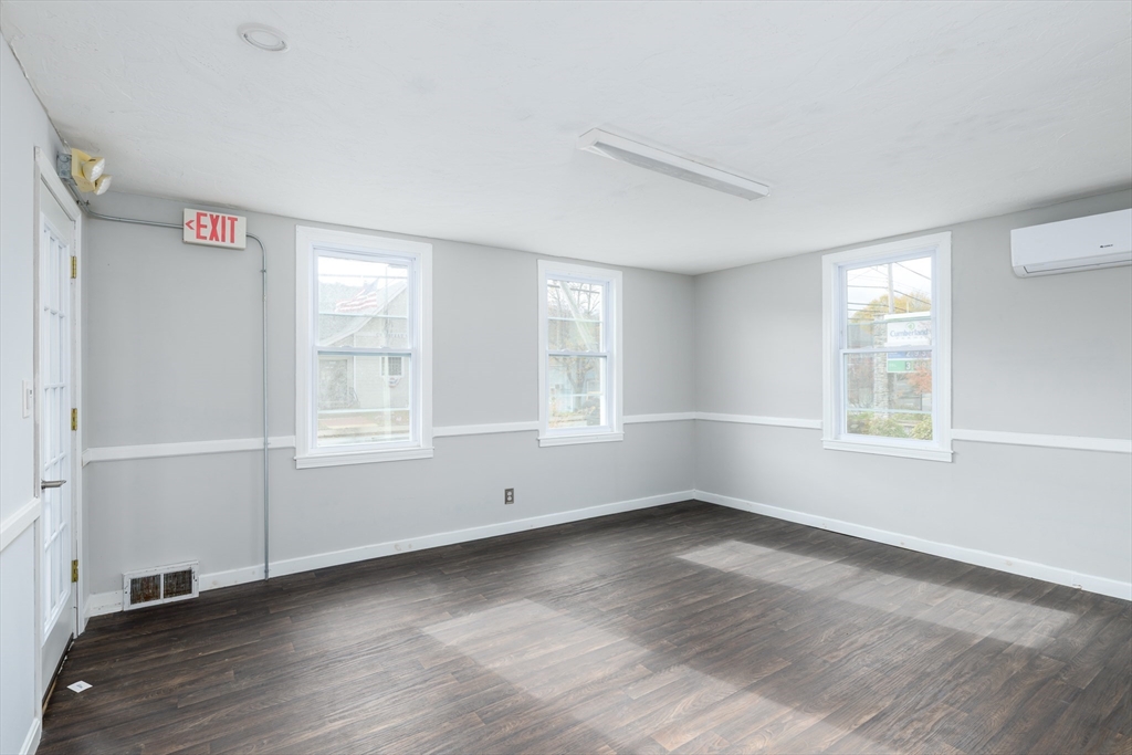504 Main Street Sturbridge, MA 01518 - Photo 20 of 25 an empty room with wooden floor and windows