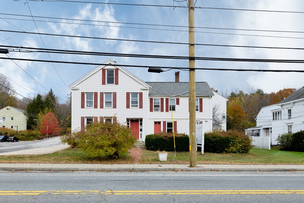 504 Main Street Sturbridge, MA 01518 - Photo 2 of 25 a front view of a building with a garden and plants