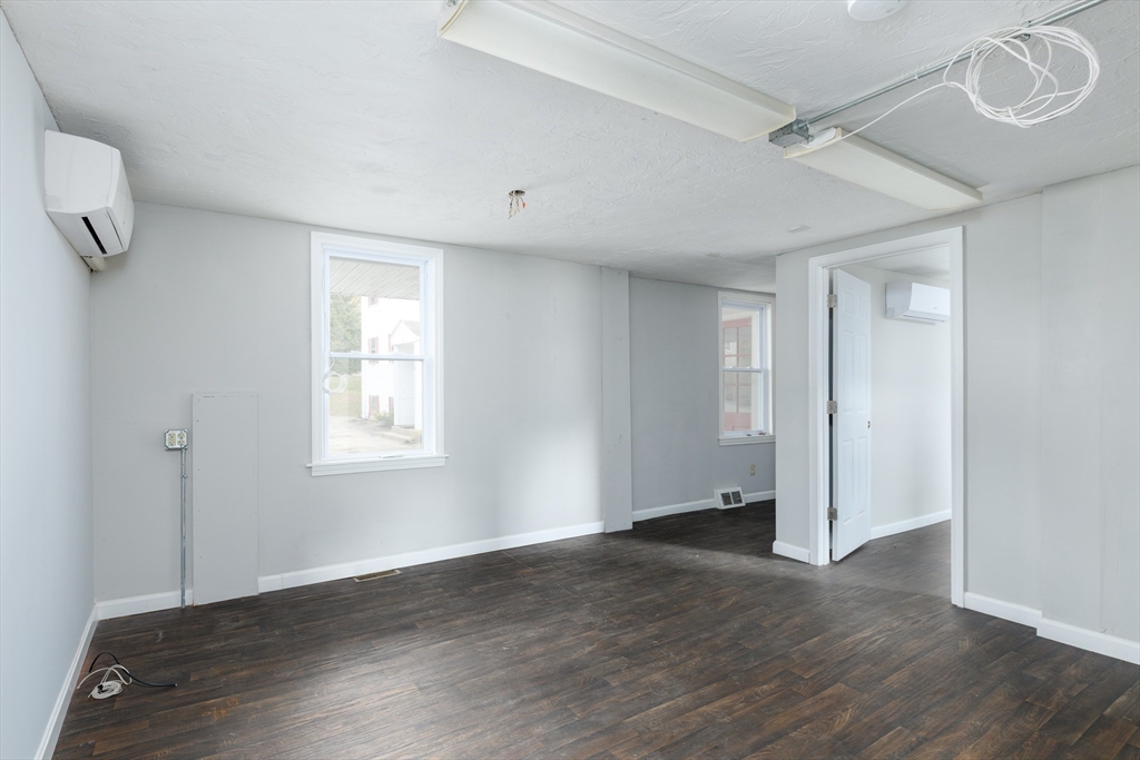 504 Main Street Sturbridge, MA 01518 - Photo 21 of 25 an empty room with wooden floor and windows