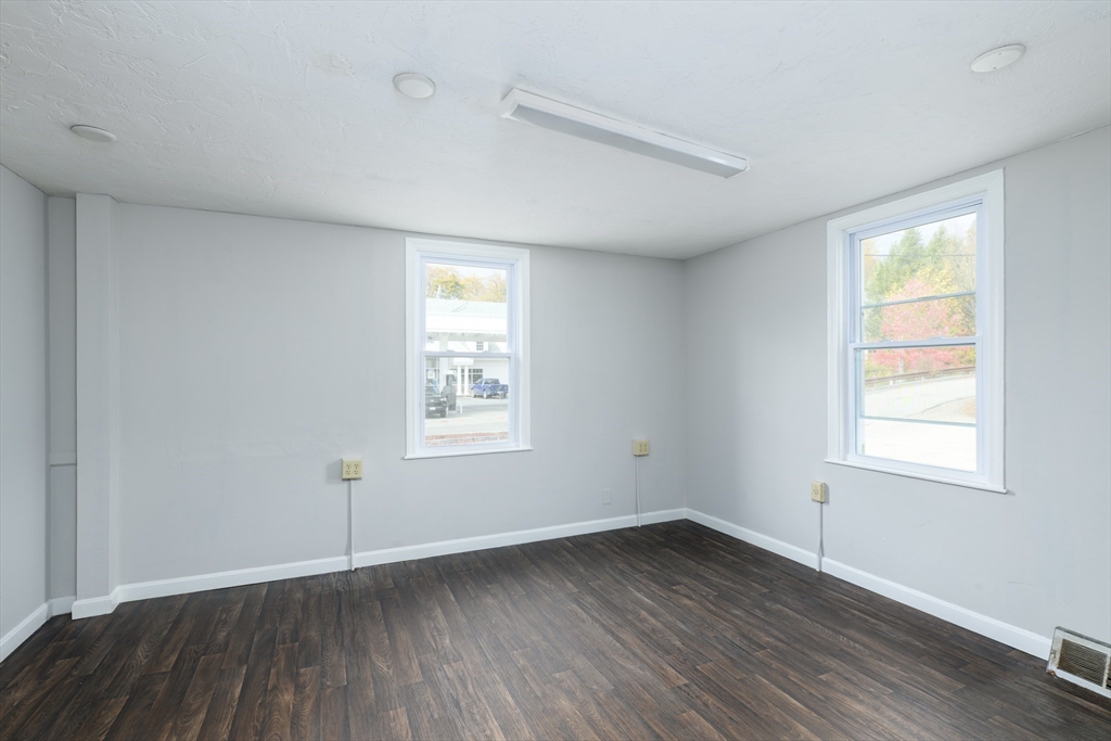 504 Main Street Sturbridge, MA 01518 - Photo 23 of 25 an empty room with wooden floor and windows