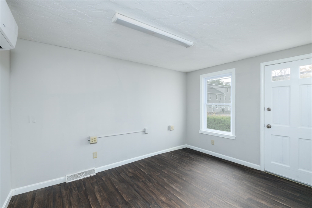504 Main Street Sturbridge, MA 01518 - Photo 7 of 25 an empty room with wooden floor and window