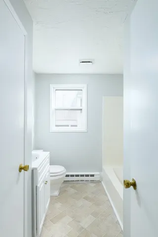a view of a bathroom with toilet