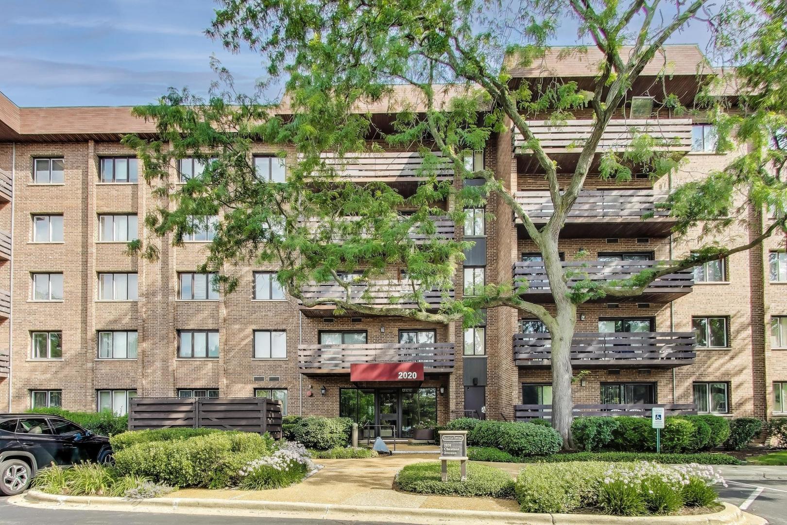 2020 Chestnut Avenue, Unit 312 Glenview, IL 60025 - Photo 1 of 34 a front view of a multi story building with yard