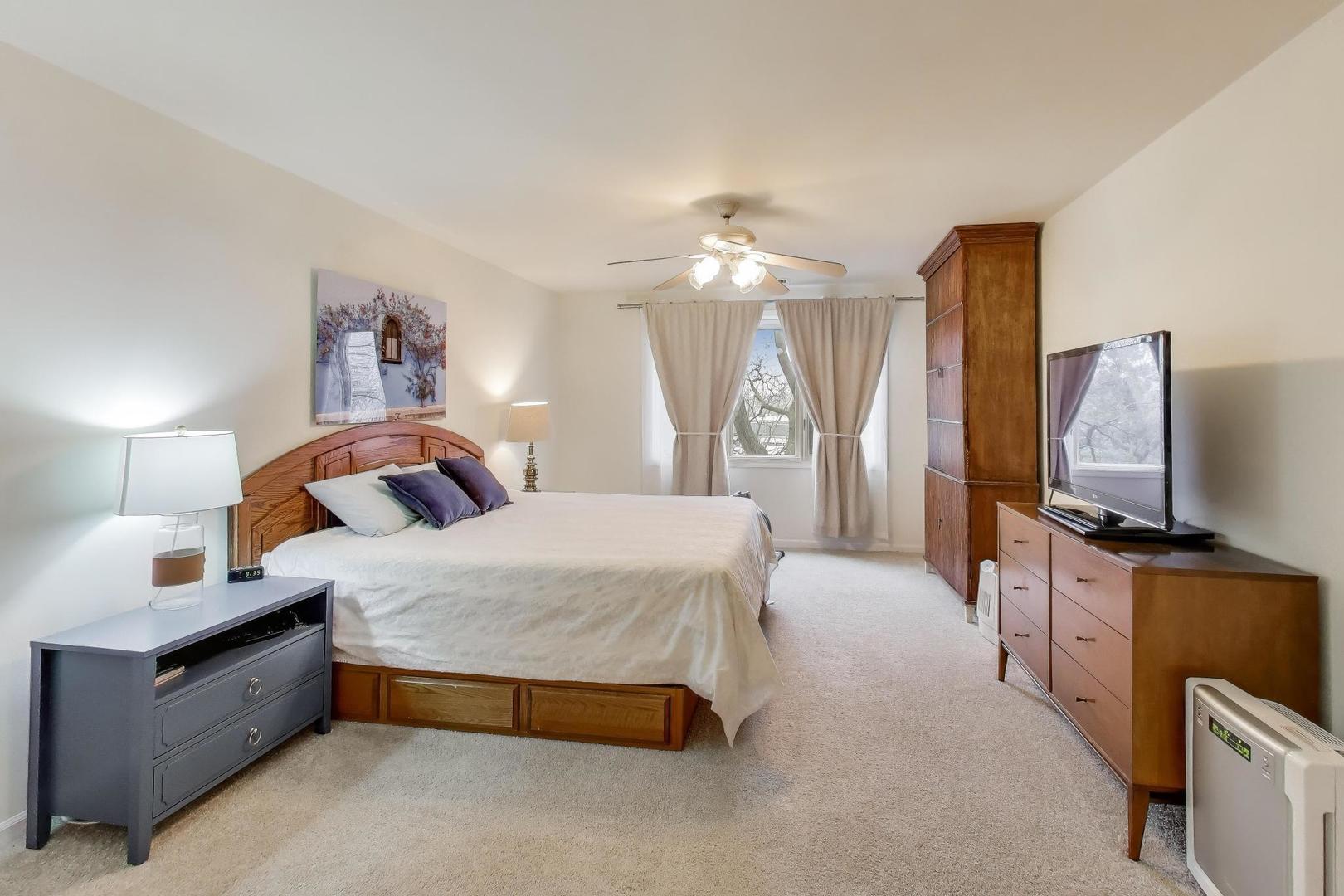 2020 Chestnut Avenue, Unit 312 Glenview, IL 60025 - Photo 14 of 34 a bedroom with a bed and a flat screen television