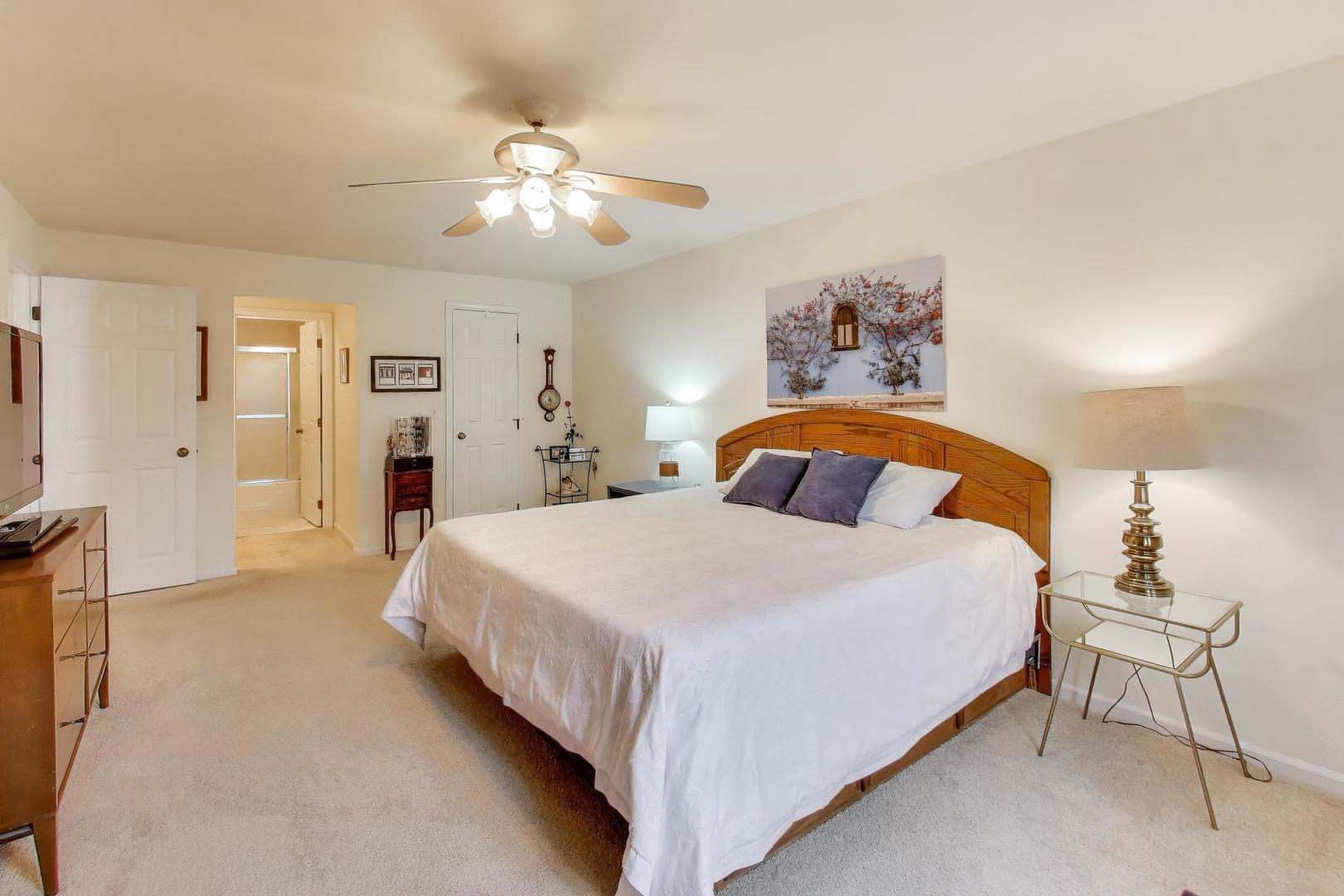 2020 Chestnut Avenue, Unit 312 Glenview, IL 60025 - Photo 15 of 34 a bedroom with a large bed and a chandelier