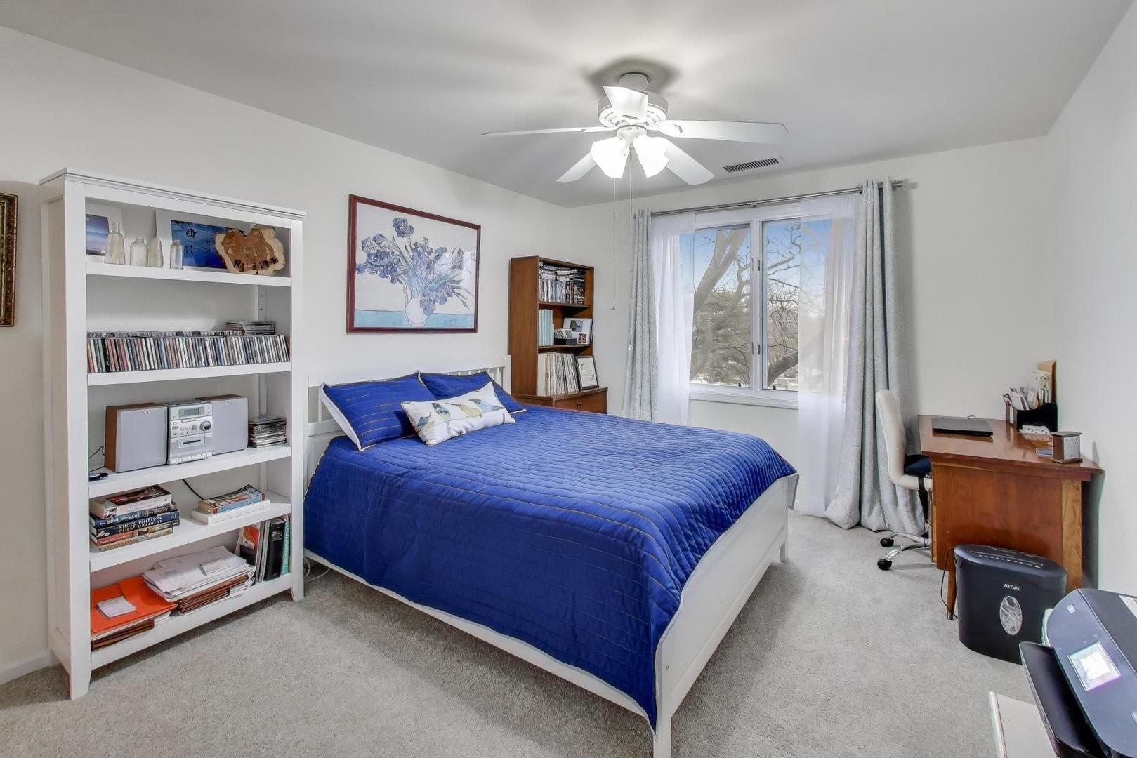 2020 Chestnut Avenue, Unit 312 Glenview, IL 60025 - Photo 18 of 34 a bedroom with a large bed and a chandelier