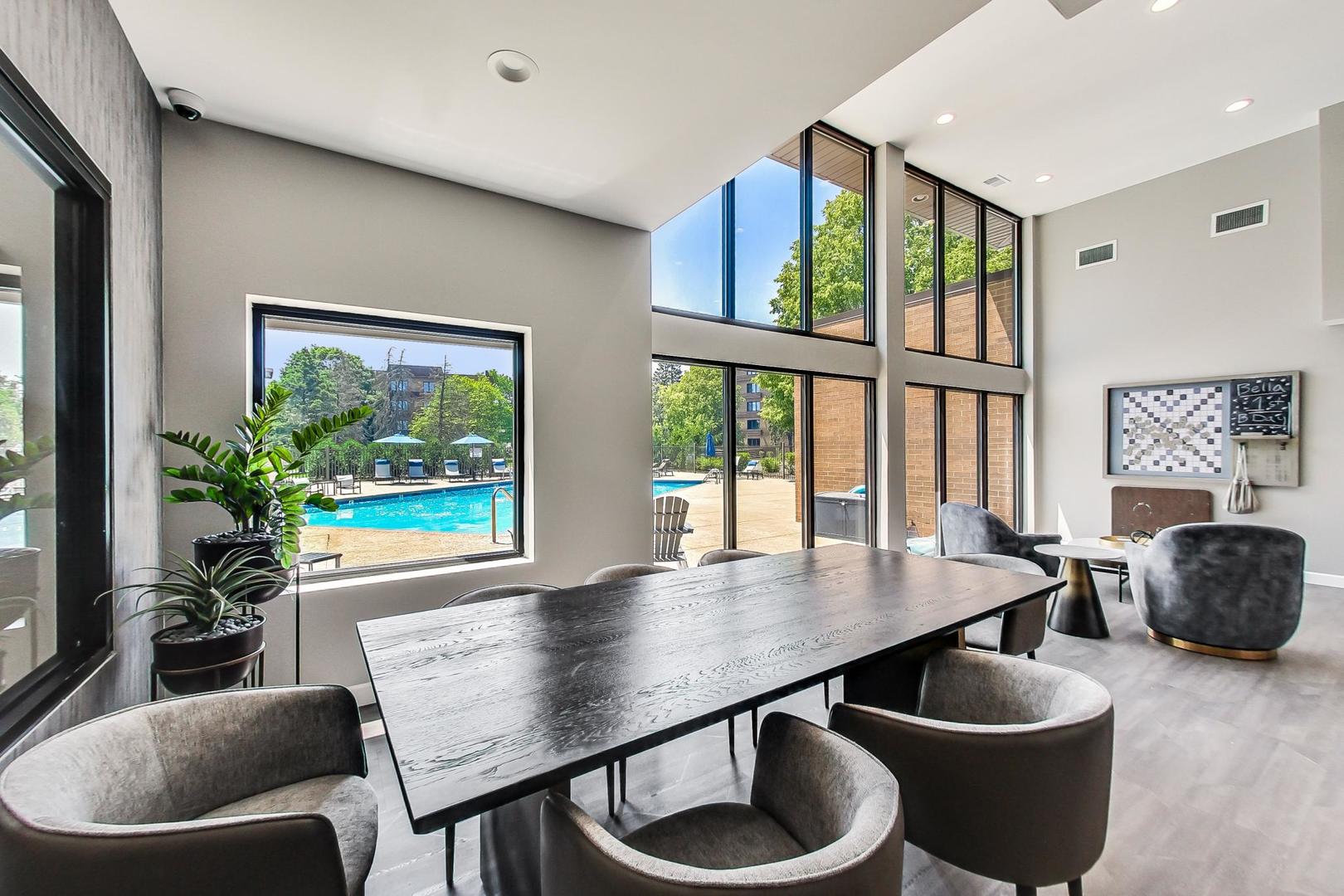 2020 Chestnut Avenue, Unit 312 Glenview, IL 60025 - Photo 24 of 34 a dining room with furniture and a floor to ceiling window