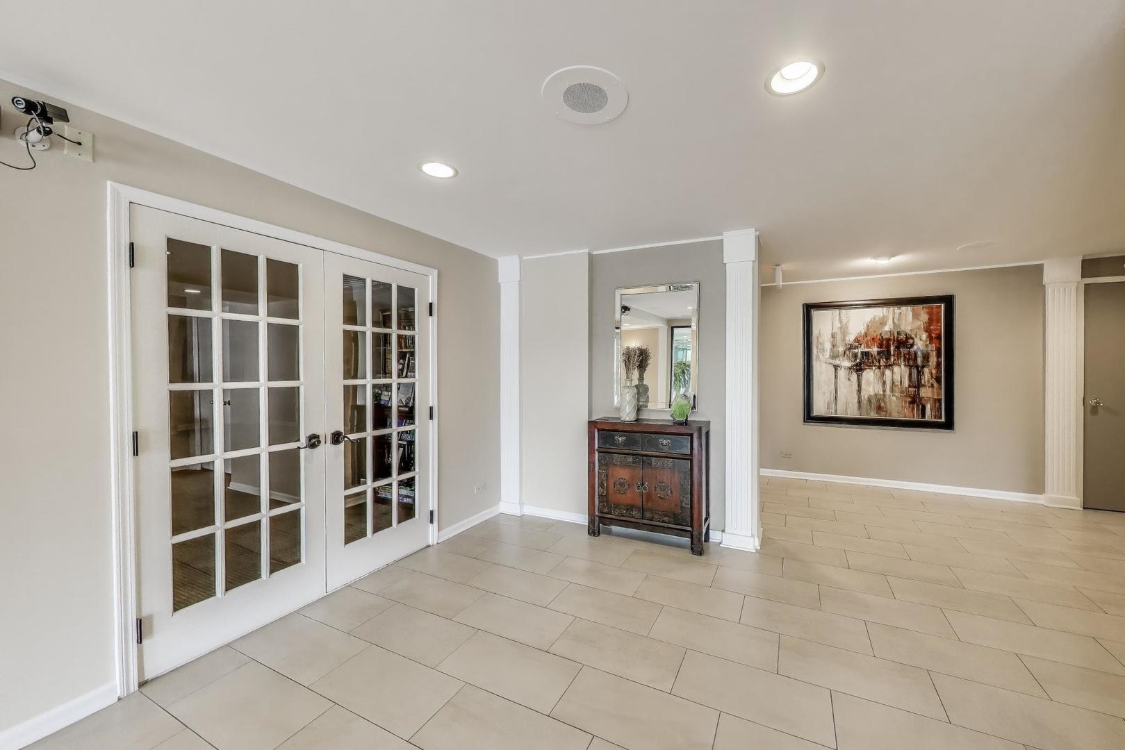 2020 Chestnut Avenue, Unit 312 Glenview, IL 60025 - Photo 3 of 34 an empty room with windows and cabinet
