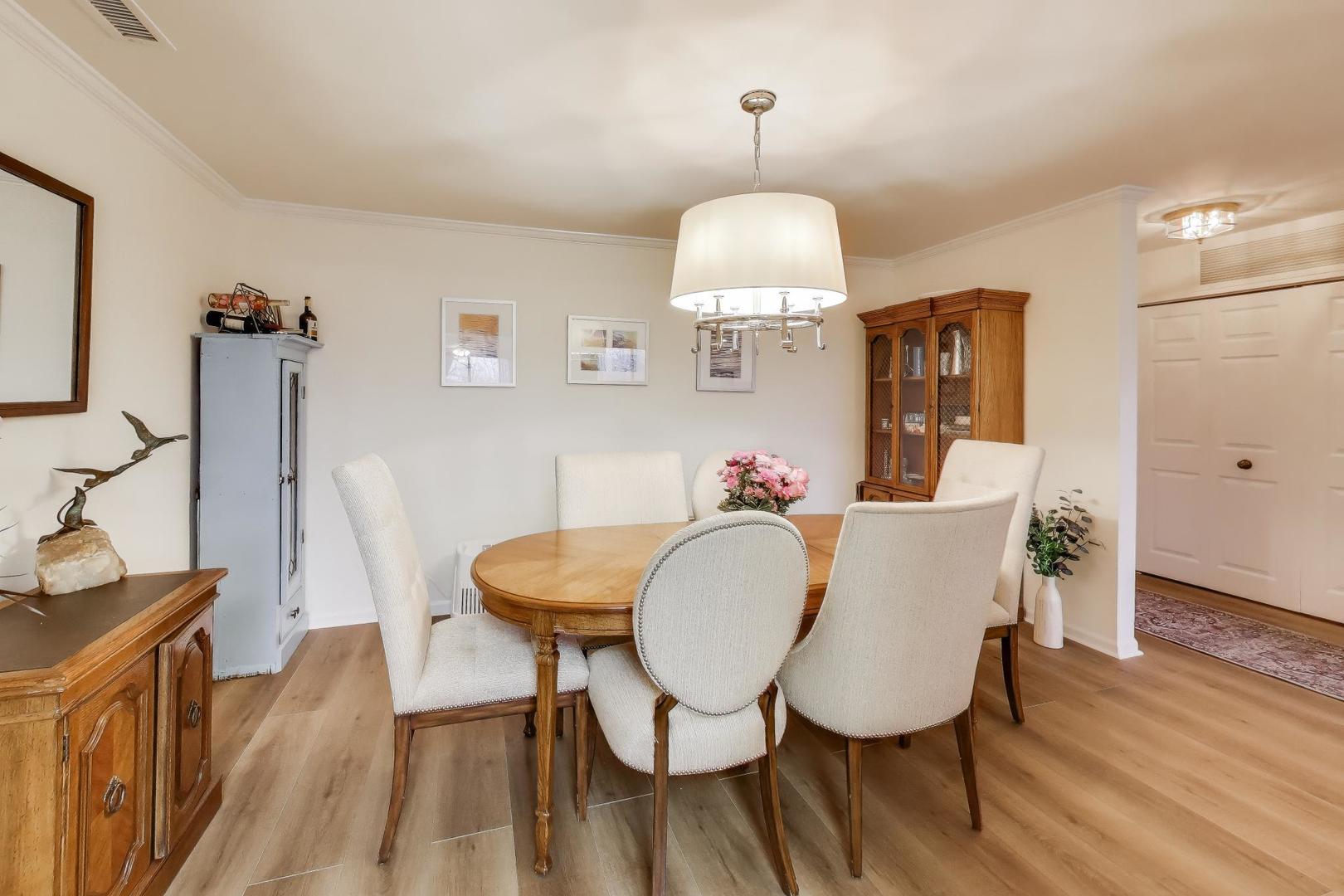 2020 Chestnut Avenue, Unit 312 Glenview, IL 60025 - Photo 8 of 34 a view of a dining room with furniture wooden floor and chandelier
