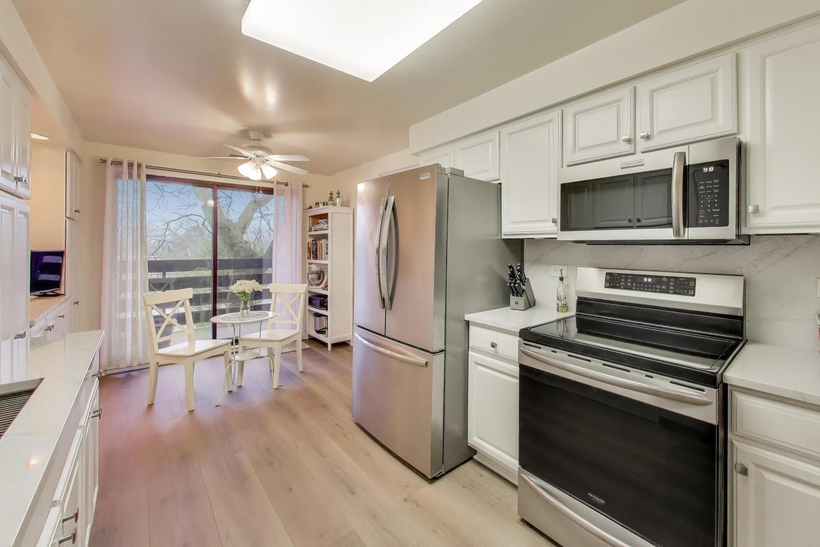 2020 Chestnut Avenue, Unit 312 Glenview, IL 60025 - Photo 10 of 34 a kitchen with stainless steel appliances a stove microwave and refrigerator