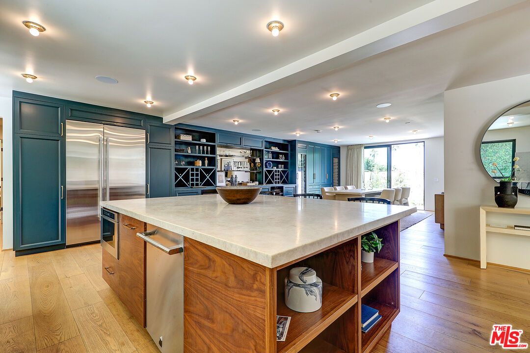 8674 Edwin Drive Los Angeles, CA 90046 - Photo 11 of 53 a kitchen with stainless steel appliances granite countertop a sink a stove and a refrigerator
