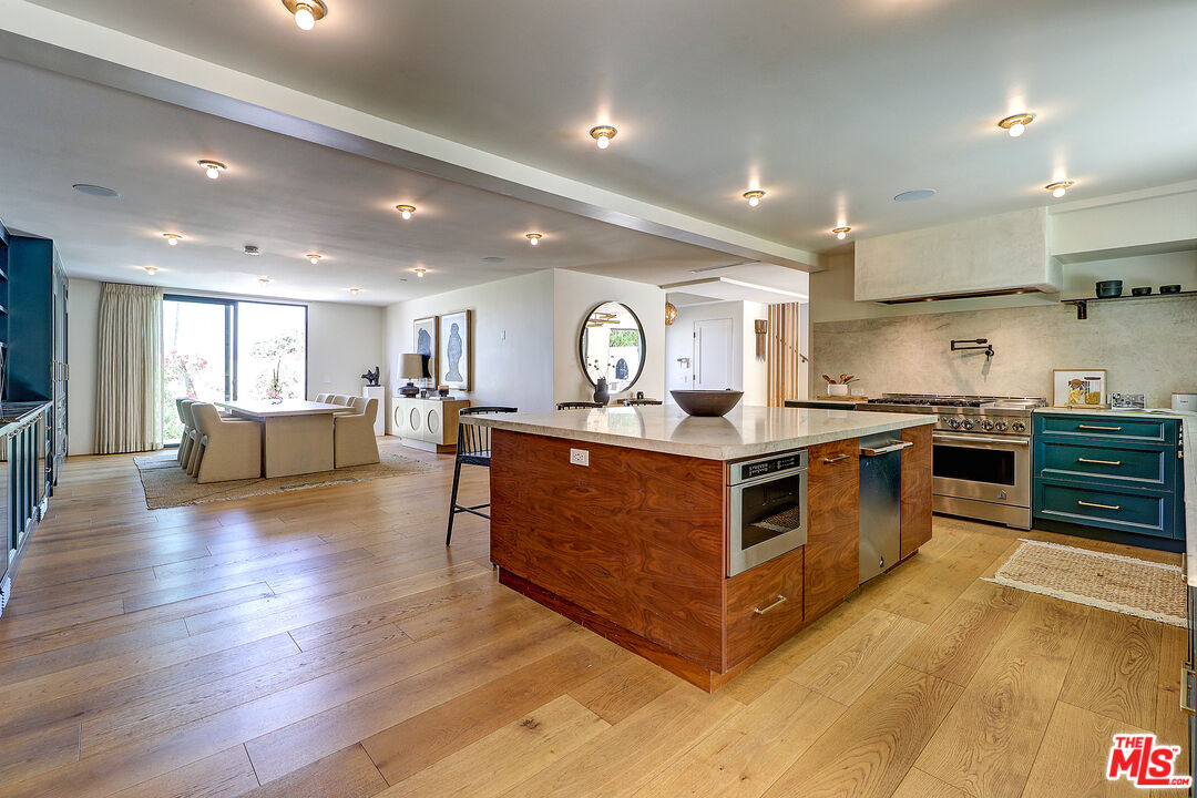 8674 Edwin Drive Los Angeles, CA 90046 - Photo 12 of 53 a large kitchen with stainless steel appliances granite countertop a large counter top and a wooden floors