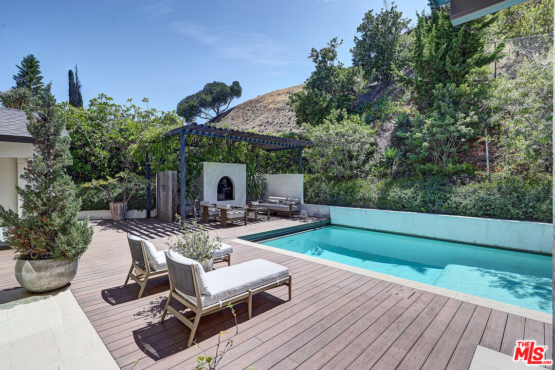8674 Edwin Drive Los Angeles, CA 90046 - Photo 19 of 53 a view of a patio with table and chairs and potted plants with wooden floor and fence