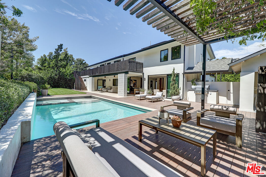 8674 Edwin Drive Los Angeles, CA 90046 - Photo 20 of 53 a view of a patio with table and chairs barbeque with wooden floor and fence
