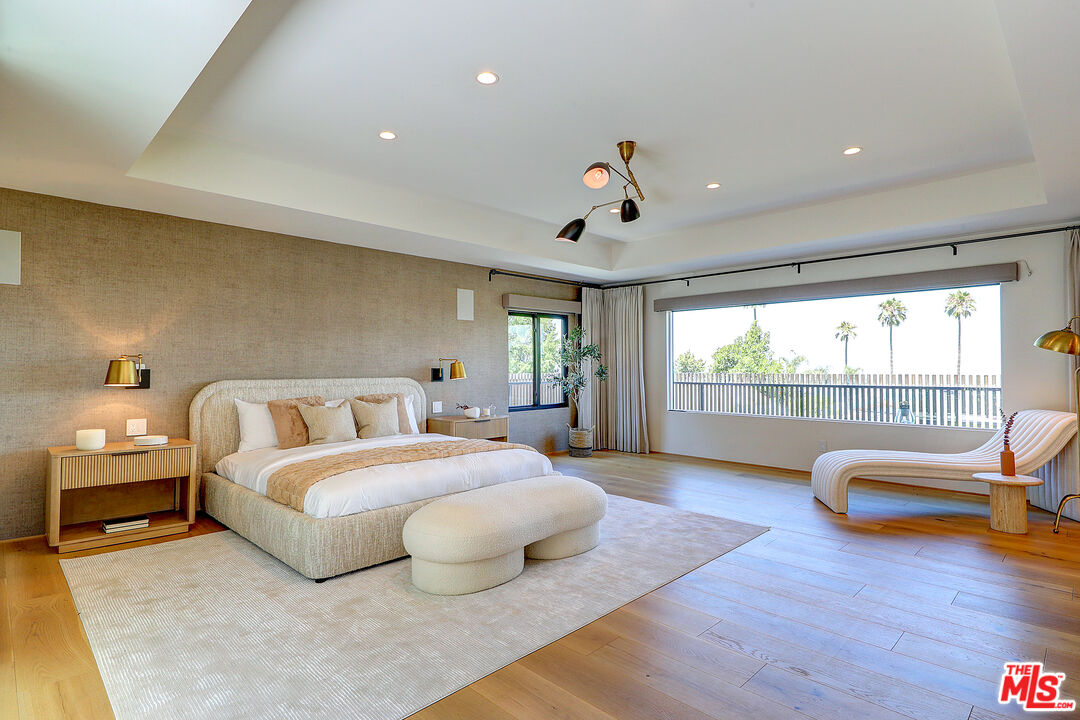 8674 Edwin Drive Los Angeles, CA 90046 - Photo 24 of 53 a bedroom with a bed and wooden floor