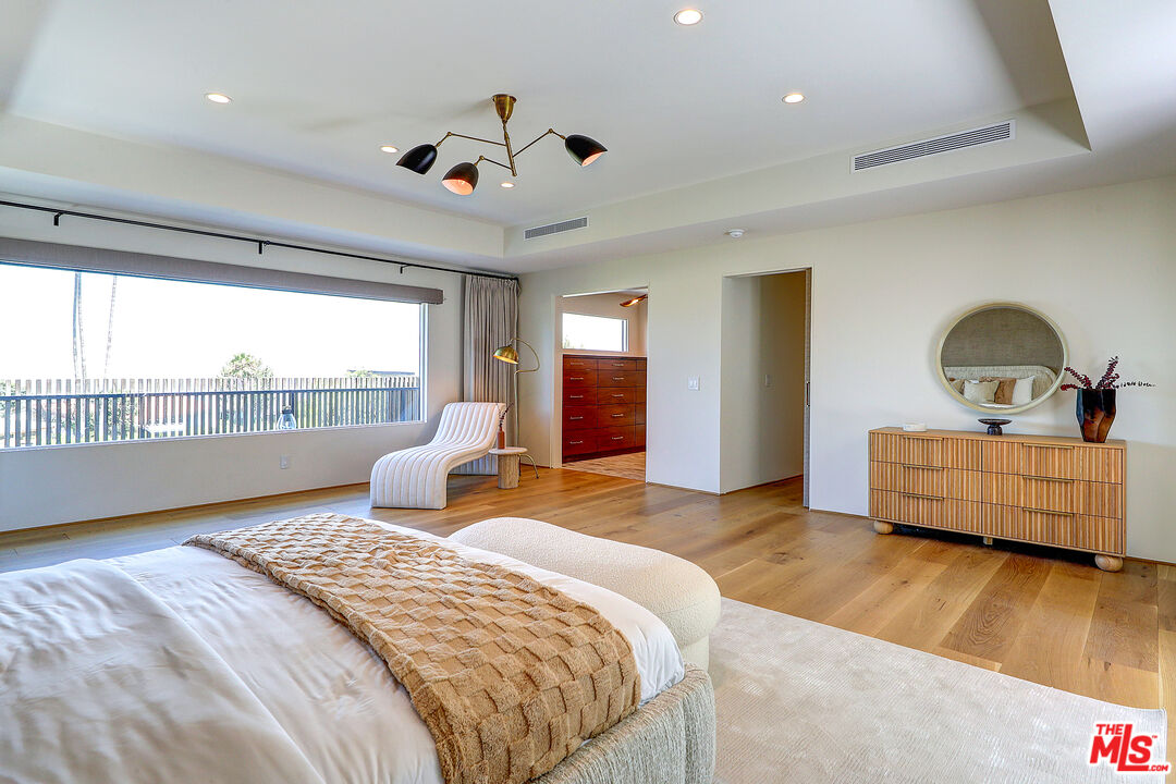 8674 Edwin Drive Los Angeles, CA 90046 - Photo 31 of 53 a bedroom with a bed and wooden floor