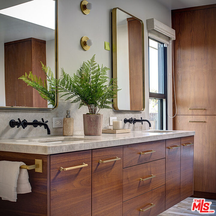 8674 Edwin Drive Los Angeles, CA 90046 - Photo 34 of 53 a bathroom with a double vanity sink and a mirror