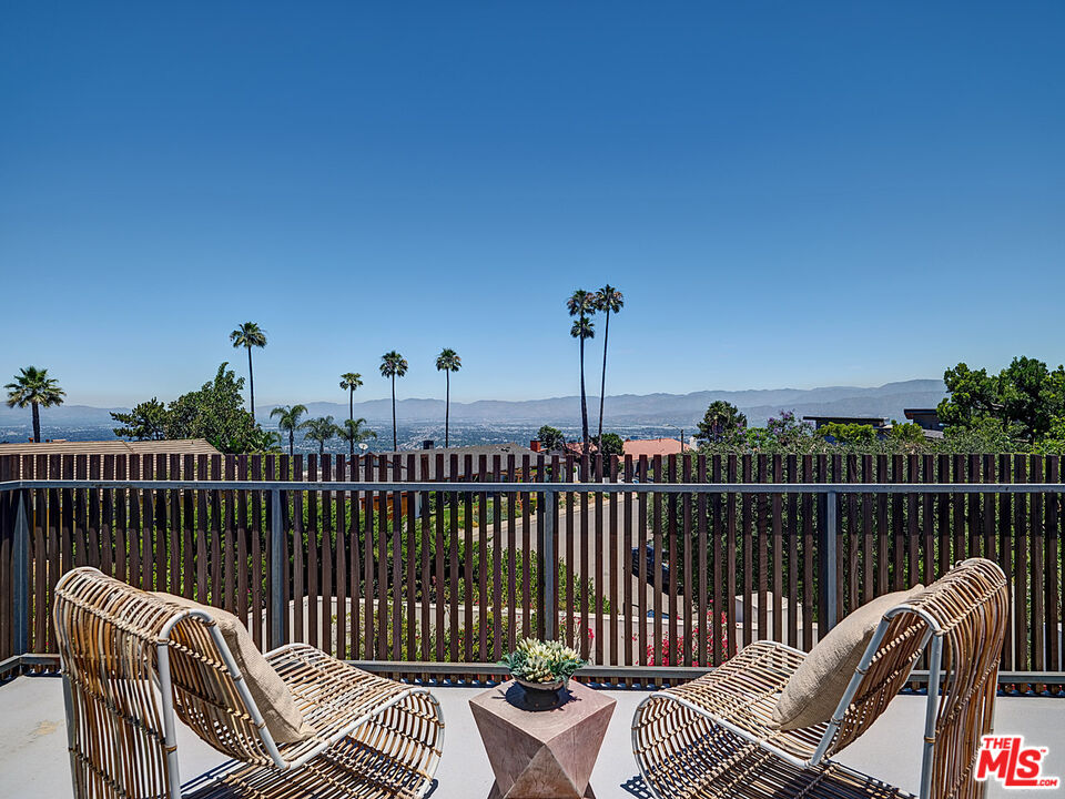 8674 Edwin Drive Los Angeles, CA 90046 - Photo 42 of 53 a view of a roof deck with chair and wooden floor