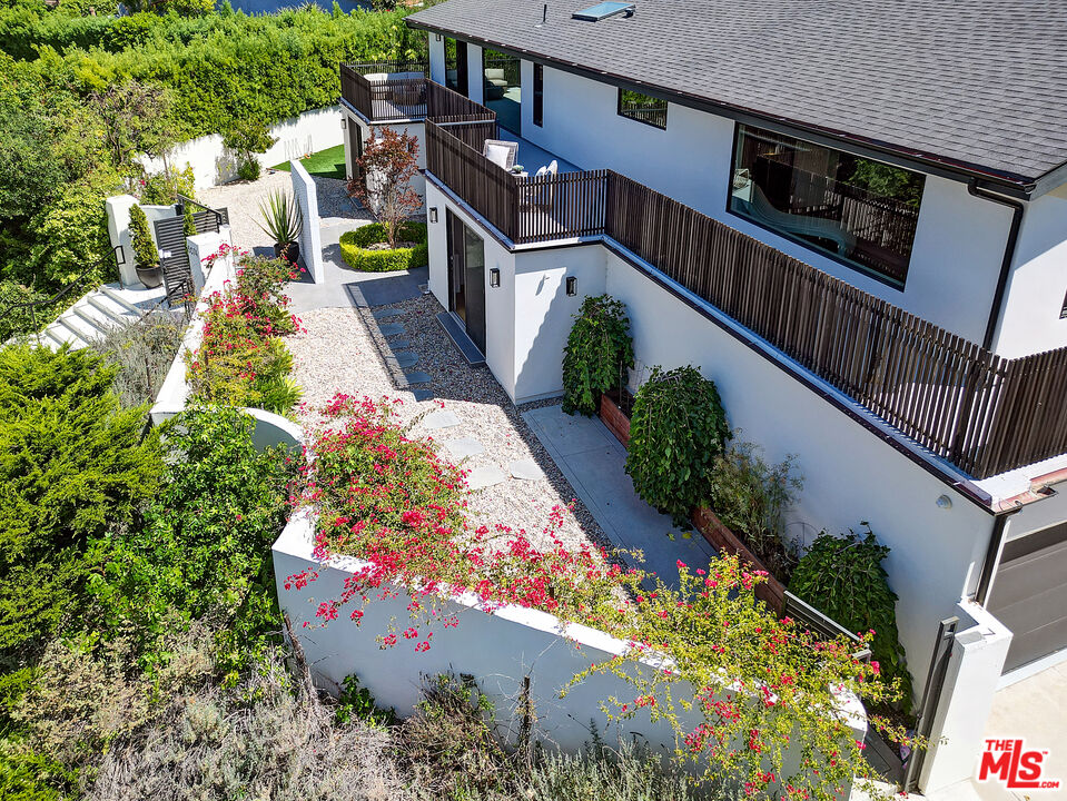 8674 Edwin Drive Los Angeles, CA 90046 - Photo 47 of 53 a view of a house with large trees and flower plants