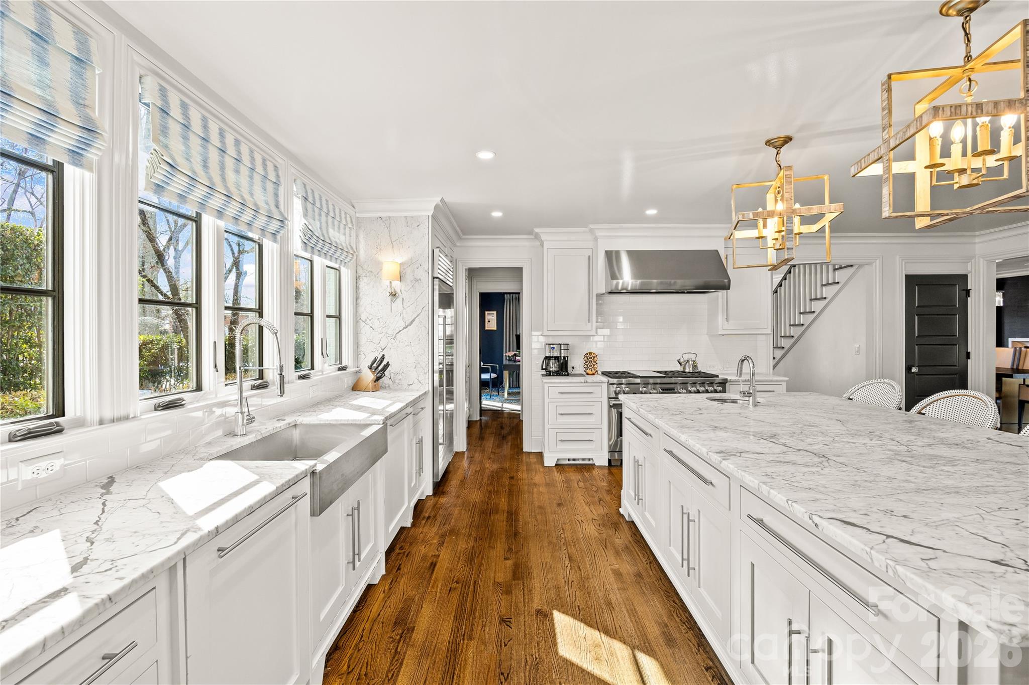 1935 Queens Road West Charlotte, NC 28207 - Photo 14 of 48 a large kitchen with kitchen island a large counter space a sink appliances and cabinets