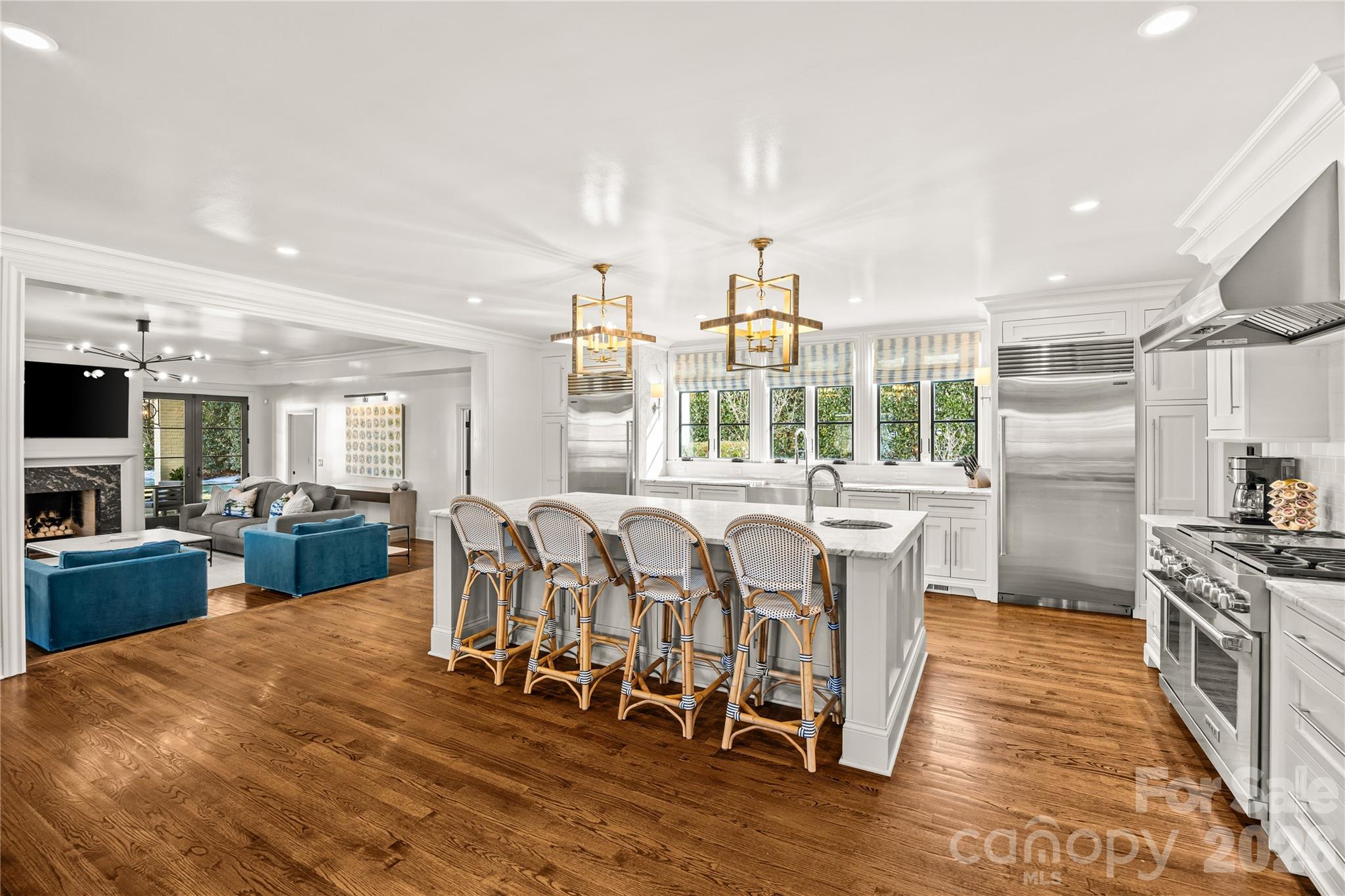 1935 Queens Road West Charlotte, NC 28207 - Photo 19 of 48 a kitchen with stainless steel appliances wooden floor dining table and chairs