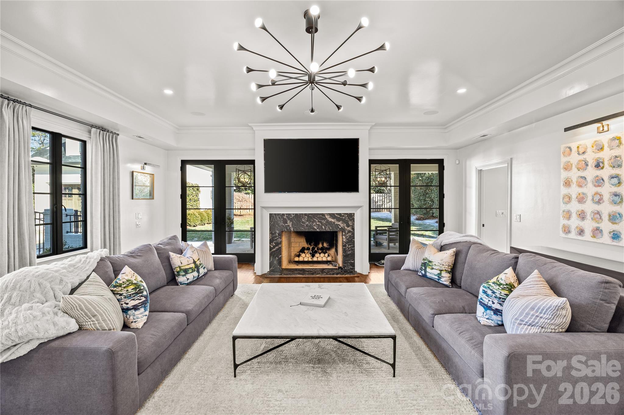 1935 Queens Road West Charlotte, NC 28207 - Photo 24 of 48 a living room with furniture a fireplace and a flat screen tv