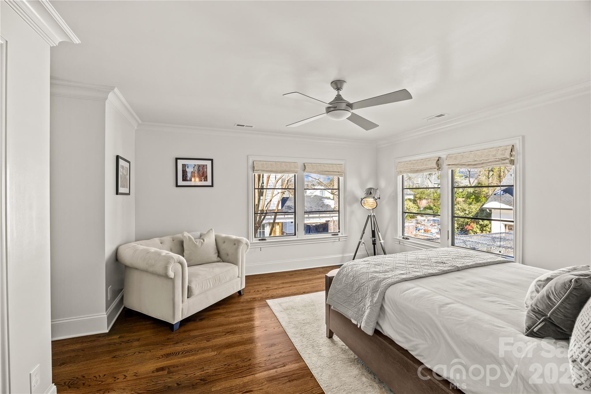 1935 Queens Road West Charlotte, NC 28207 - Photo 40 of 48 a spacious bedroom with a bed a couch and a window