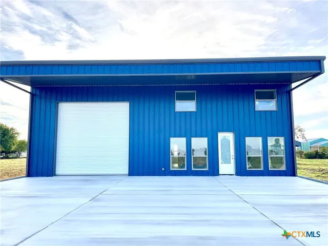 a view of a house with a yard and garage