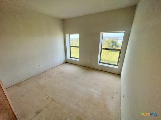 a view of an empty room with closet