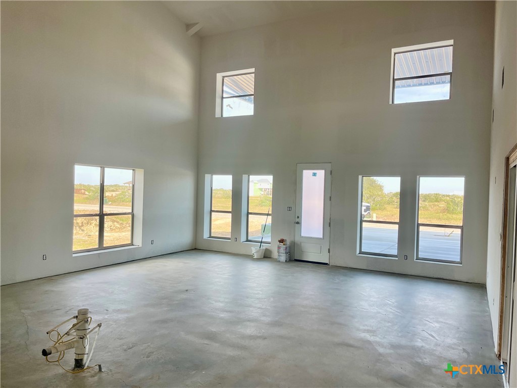 29 Carrie Street Port O'Connor, TX 77982 - Photo 7 of 29 wooden floor in an empty room with a window