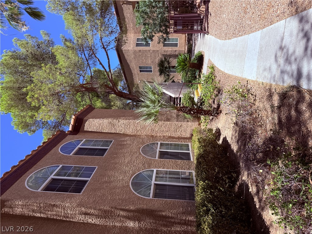 9325 West Desert Inn Road, Unit 260 Las Vegas, NV 89117 - Photo 24 of 42 Textured facade with arched windows and a tile roof define this charming residence.