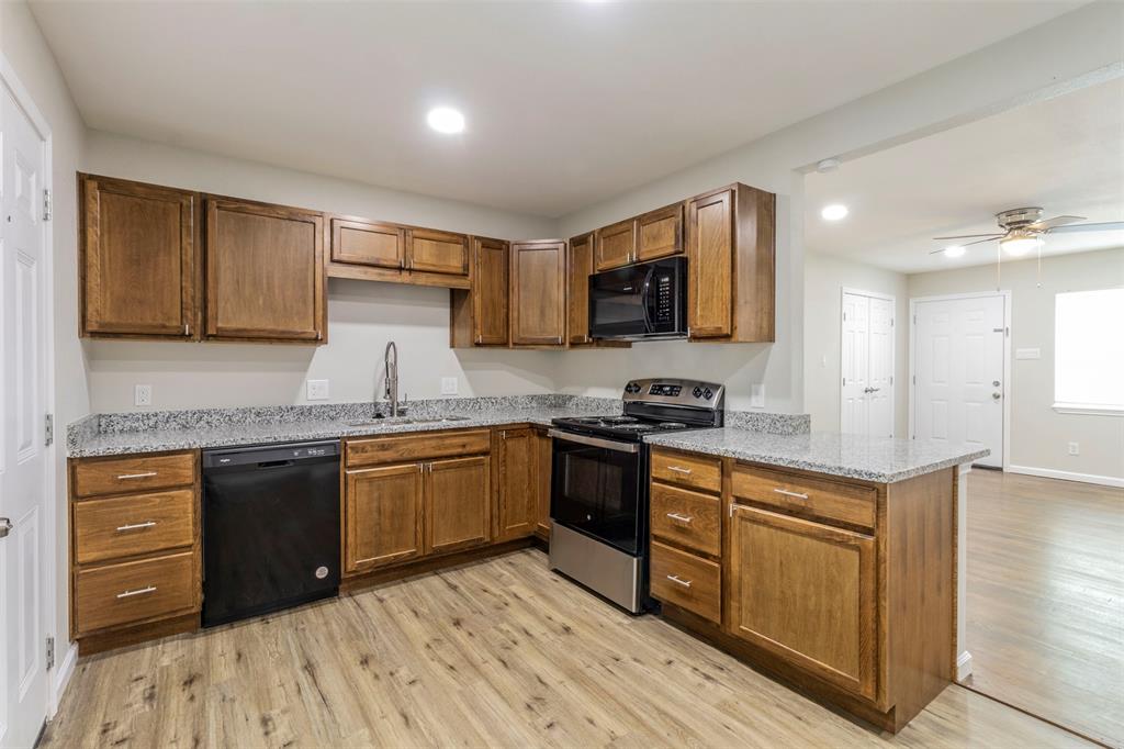 a kitchen with stainless steel appliances granite countertop a sink and cabinets