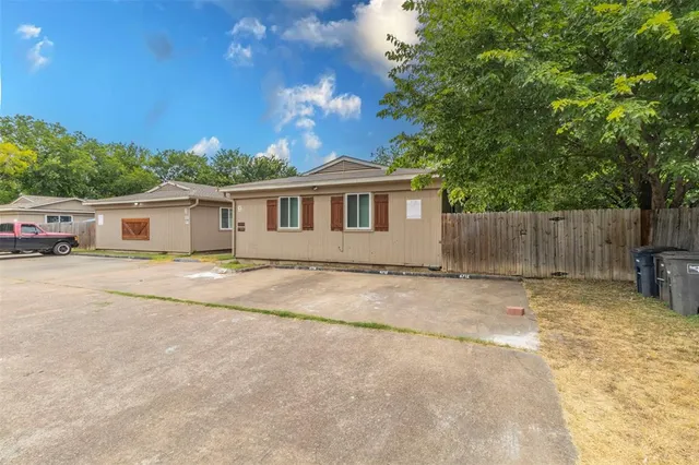a view of a house with a backyard and a tree