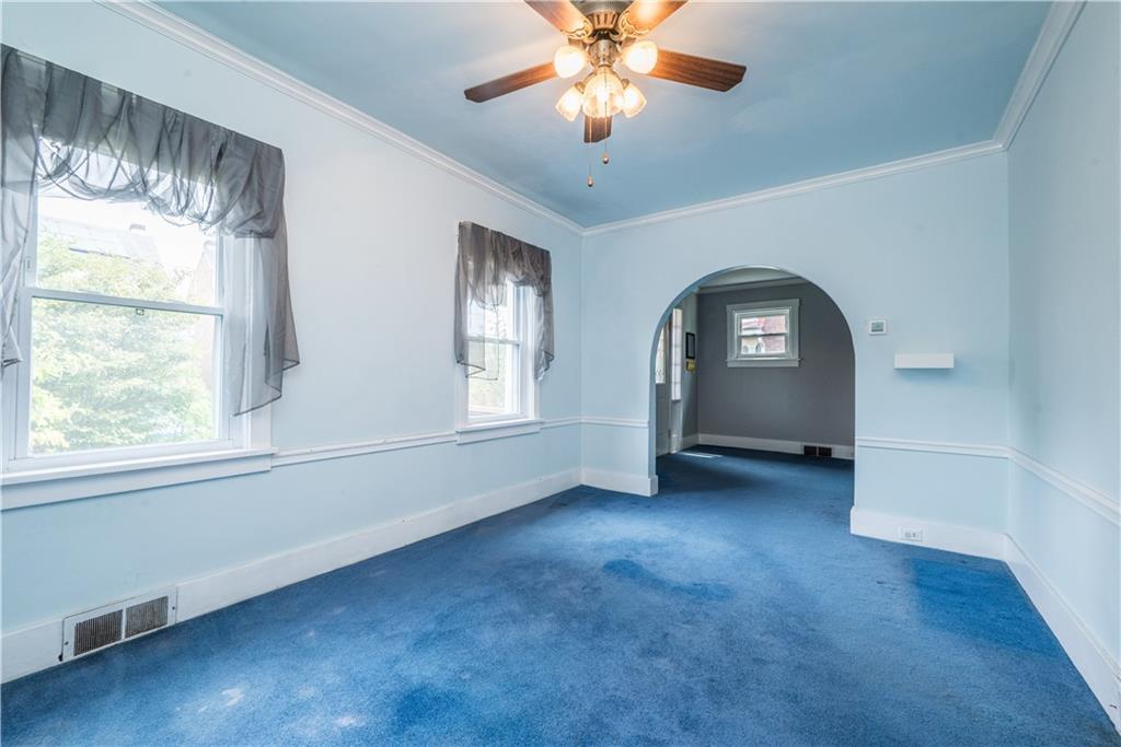 1819 Viruth Street Pittsburgh, PA 15212 - Photo 11 of 50 an empty room with windows and fireplace