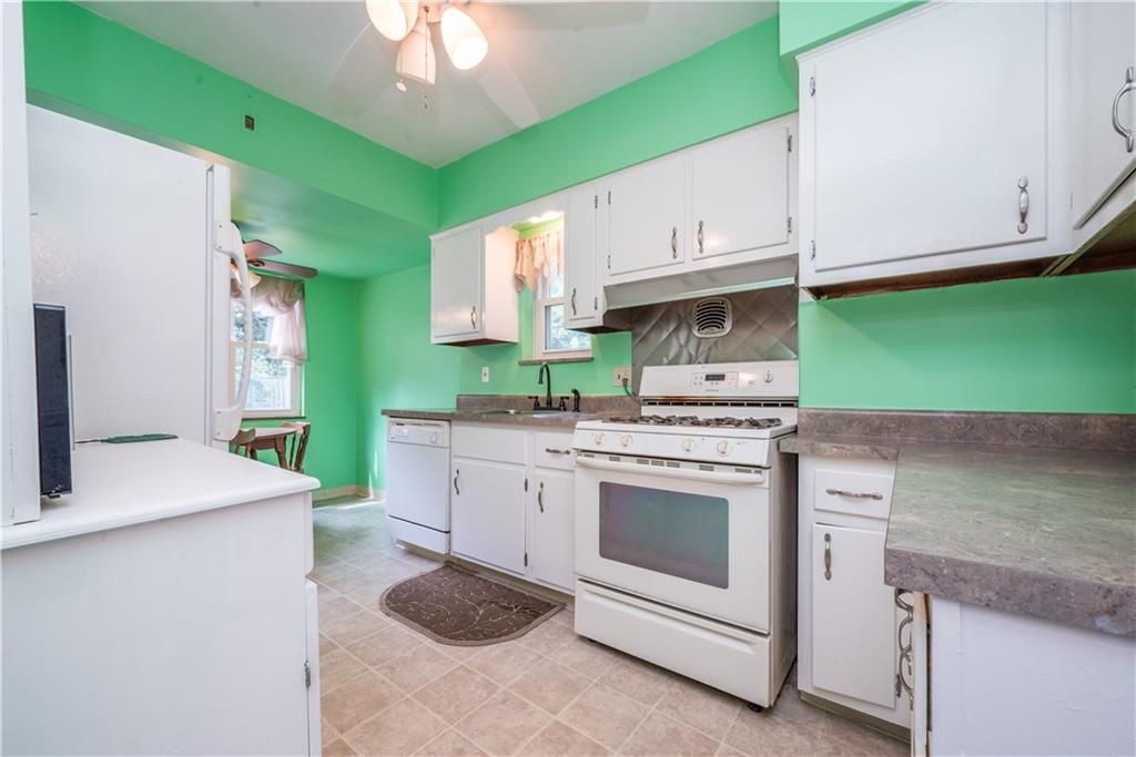 1819 Viruth Street Pittsburgh, PA 15212 - Photo 13 of 50 a kitchen with kitchen island a sink stove and cabinets