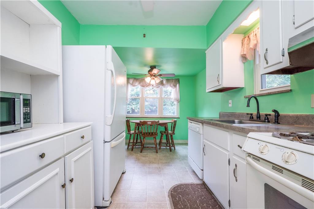1819 Viruth Street Pittsburgh, PA 15212 - Photo 14 of 50 a kitchen with a sink cabinets and wooden floor