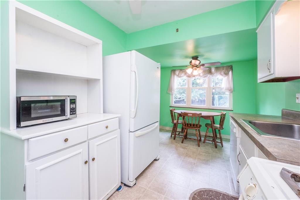 1819 Viruth Street Pittsburgh, PA 15212 - Photo 15 of 50 a kitchen with kitchen island a table and chairs in it