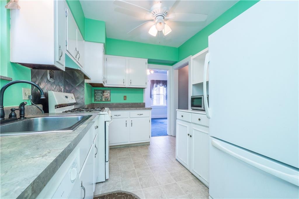 1819 Viruth Street Pittsburgh, PA 15212 - Photo 16 of 50 a kitchen with granite countertop a sink stainless steel appliances and cabinets