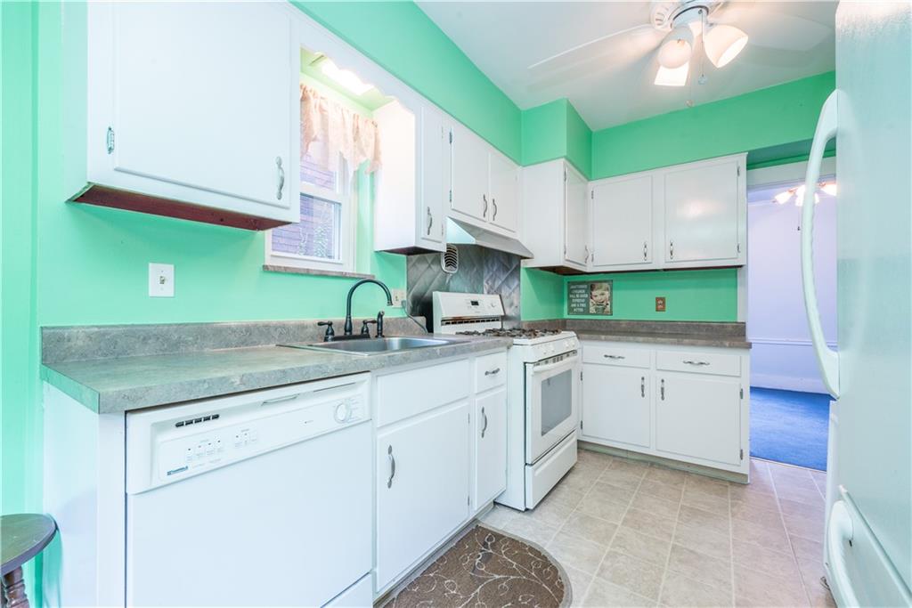 1819 Viruth Street Pittsburgh, PA 15212 - Photo 18 of 50 a kitchen with granite countertop a sink and a stove