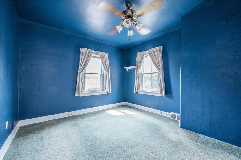 1819 Viruth Street Pittsburgh, PA 15212 - Photo 25 of 50 an empty room with windows and chandelier fan