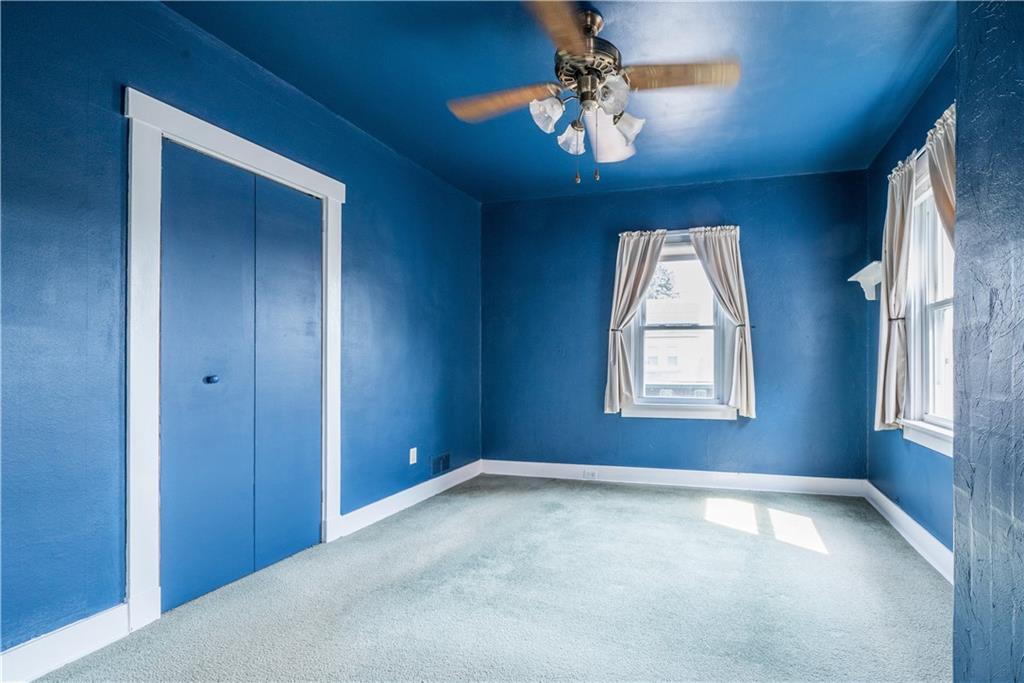1819 Viruth Street Pittsburgh, PA 15212 - Photo 26 of 50 an empty room with windows and chandelier fan